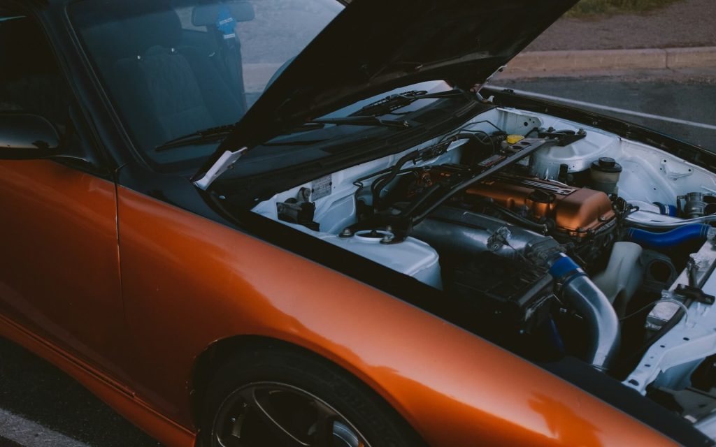 orange car open engine hood